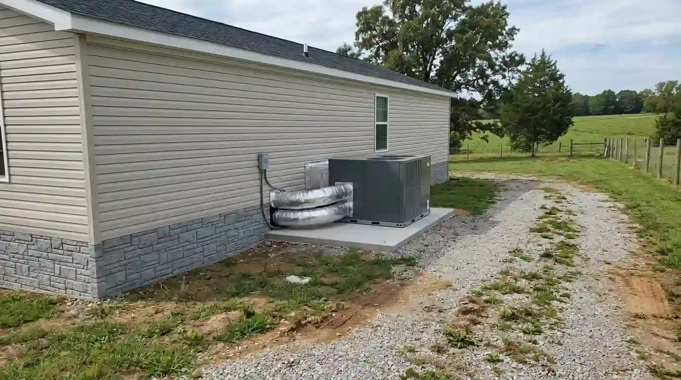 Manufactured home with a packaged heat pump on a pad